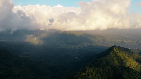 mount agung active volcano covered with clouds in bali, indonesia