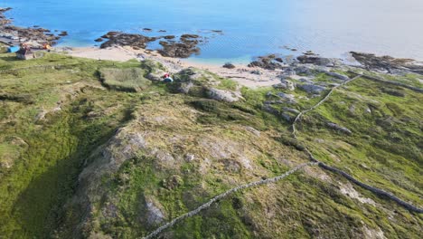 camping tents on the rocky bay of the beautiful coral strand beach in connemara, ireland - aerial