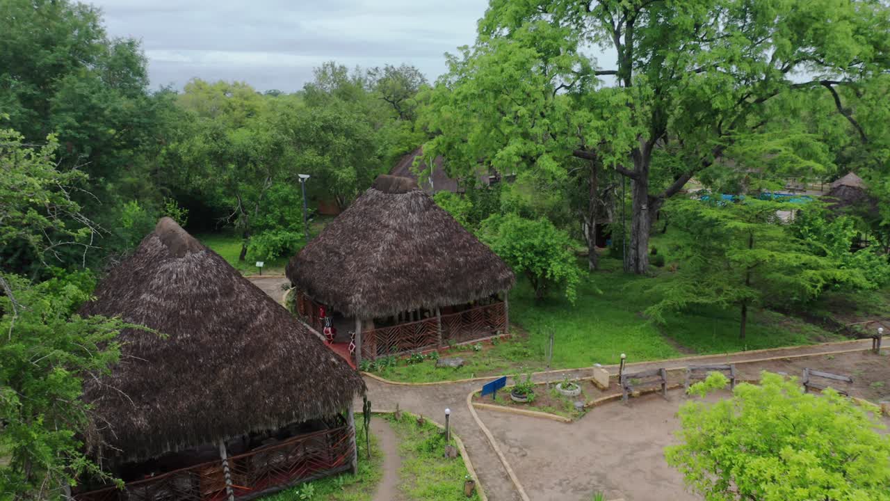 Aerial drone shot flying over a luxury lodge in Selous jungle. Tanzania, cloudy day.