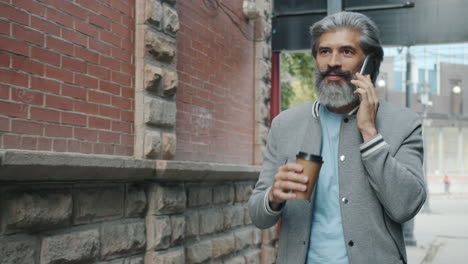 man walking and talking on phone in city street