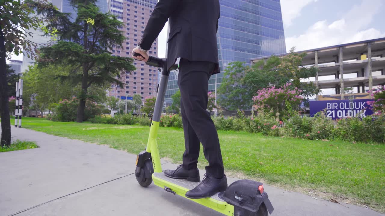 Joven empresario con traje en patinete eléctrico