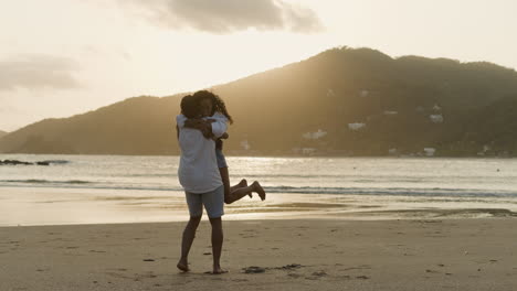 Woman jumping on his boyfriend&#039;s arms