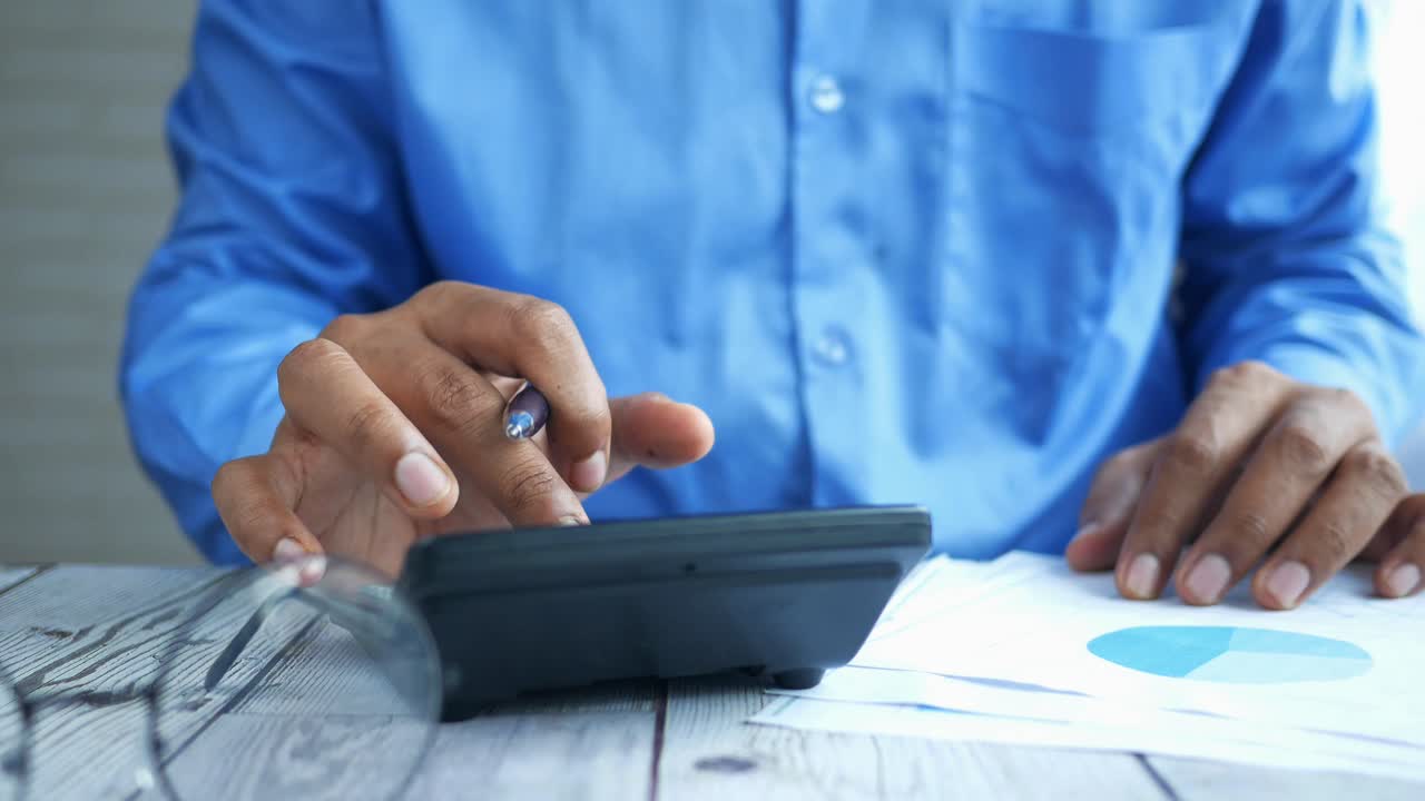 Businessman using calculator and documents