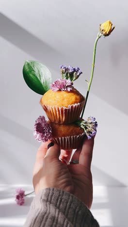 delicate cupcakes with floral arrangement