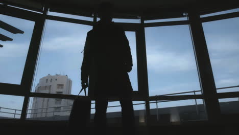 person silhouetted at window