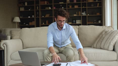 confused young man do accounting paperwork deal with financial problem