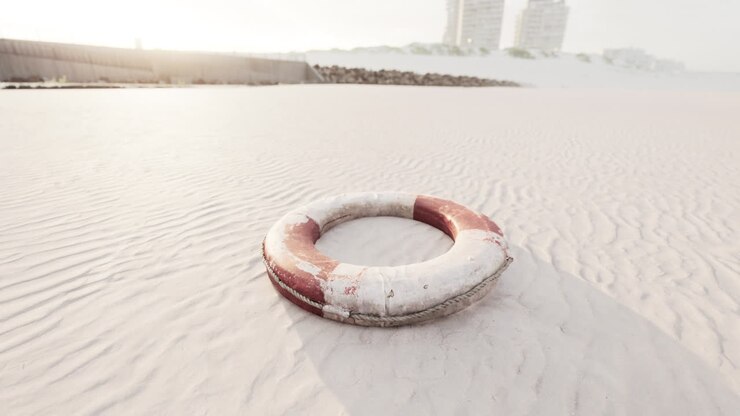Lifebuoy on the city beach at sunset