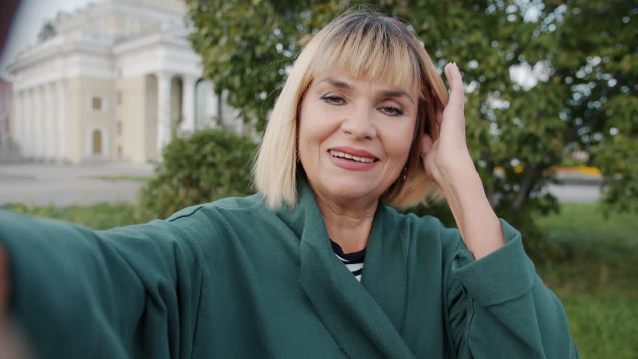 Smiling Woman Taking Selfie in a Park