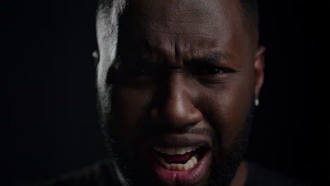 Shocked-afro-guy-yelling-indoors.-Frustrated-man-looking-at-camera-in-studio