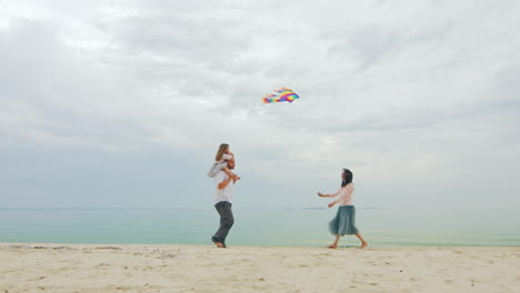 friendly young family playing with daughter fly a kite 02