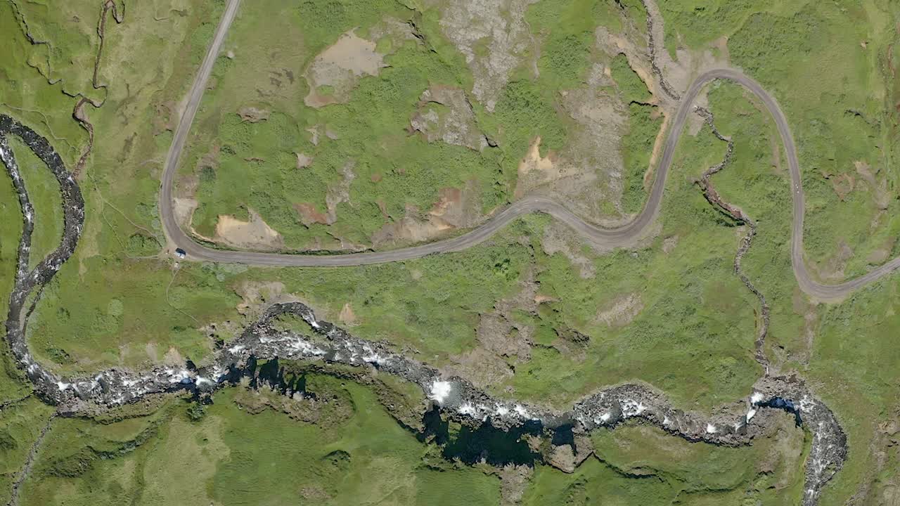 Aerial footage straight down flyover over Klifbrekkufossar waterfall running over series of ledges. Norse - icelandic water fall, drone shot top down.