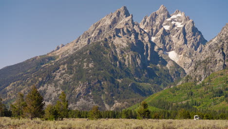 rv in a scenic mountain valley with snow-capped peaks
