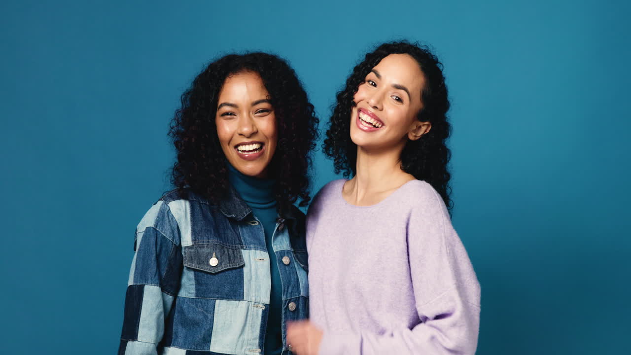 Two smiling women with curly hair