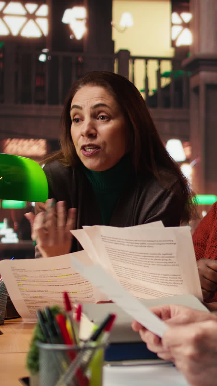 Vertical Video Cast members practicing script reading for a classic drama play in a library
