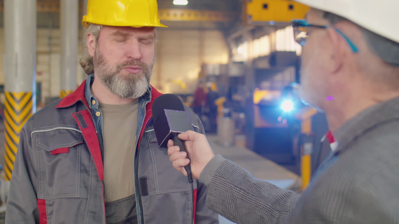 Factory Worker Giving Interview to TV Journalist