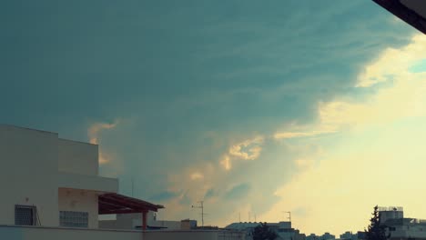 dramatic moving colorful clouds, blue and yellow sky, building rooftop, time lapse, 4k video