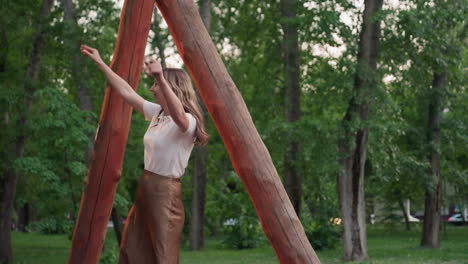 summer children swinging high under sunset through leafy park while mom supports chains with caring touch capturing joyful laughter affectionate bond in warm evening light outdoors smiles