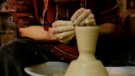 professional male potter working in workshop