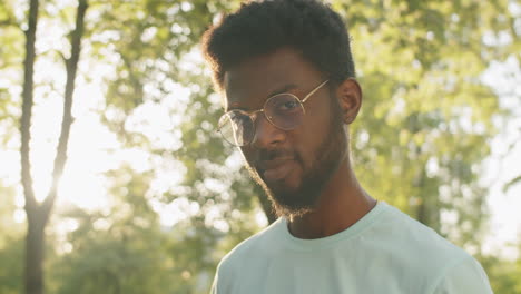 portrait of young african american  man outdoors on sunny day