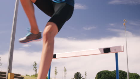 sportswoman doing hurdle race