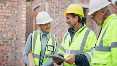 construction workers discussing plans on a building site