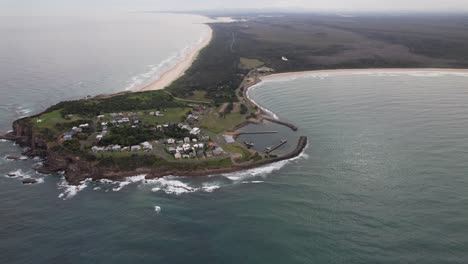 panoramic view over crowdy head with harrington beach and kylies beach, nsw, australia - drone shot