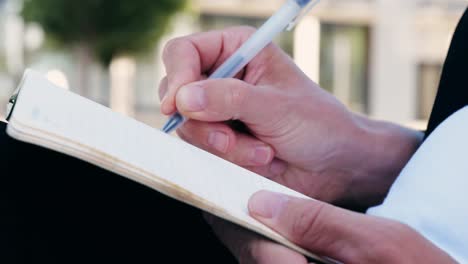 person writing in a notepad