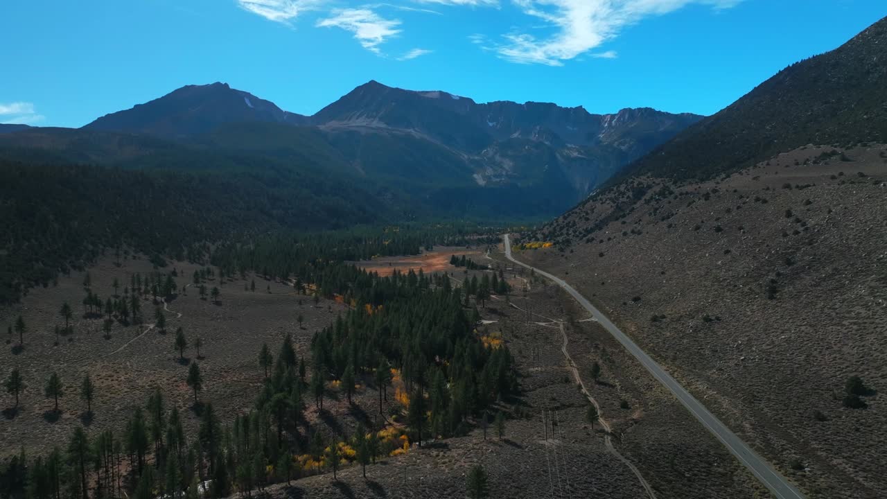 West Portal Entrance Mountains Lee Vining Tioga Pass Road Yosemite National Park California aerial drone Ansel Adams Wilderness Big Oak Flat fall yellow orange Aspen Trees blue skies backwards pan up