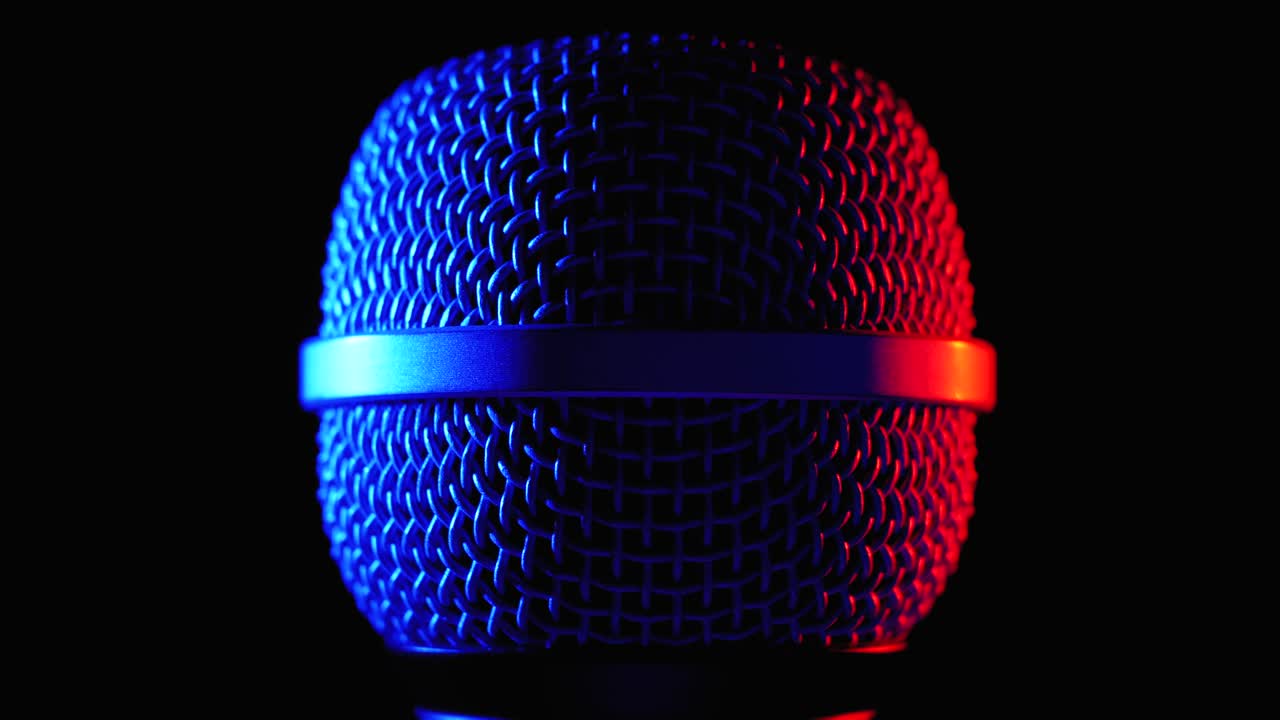 Microphone Rotates with Blue and Red Backlight. Dynamic Microphone Grid Spins Close-up