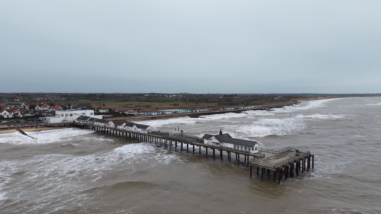 Southwold Pier in winter rough seas drone,aerial Suffolk UK slow motion waves