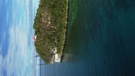 Chapelle-Notre-Dame-de-Lourdes-on-island-of-Lifou,-vertical-aerial-dolly-forward