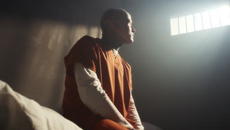 tattooed prisoner suffering from emotional anguish in jail