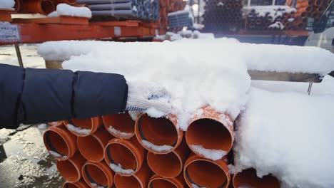 orange pvc pipes stacked in construction site