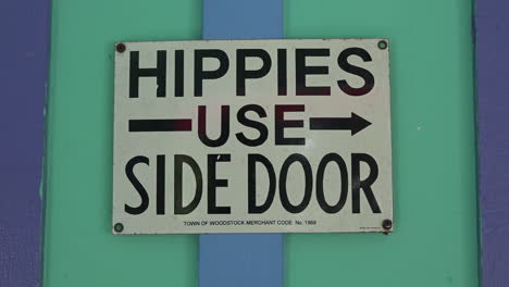 A sign urges hippies to use the side door