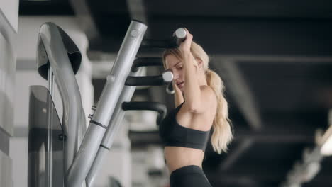 Fitness-girl-doing-pull-ups-exercises-in-modern-gym.