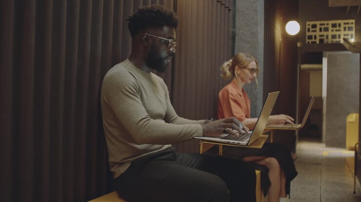 Freelancers Working on Laptops in Modern Cafe