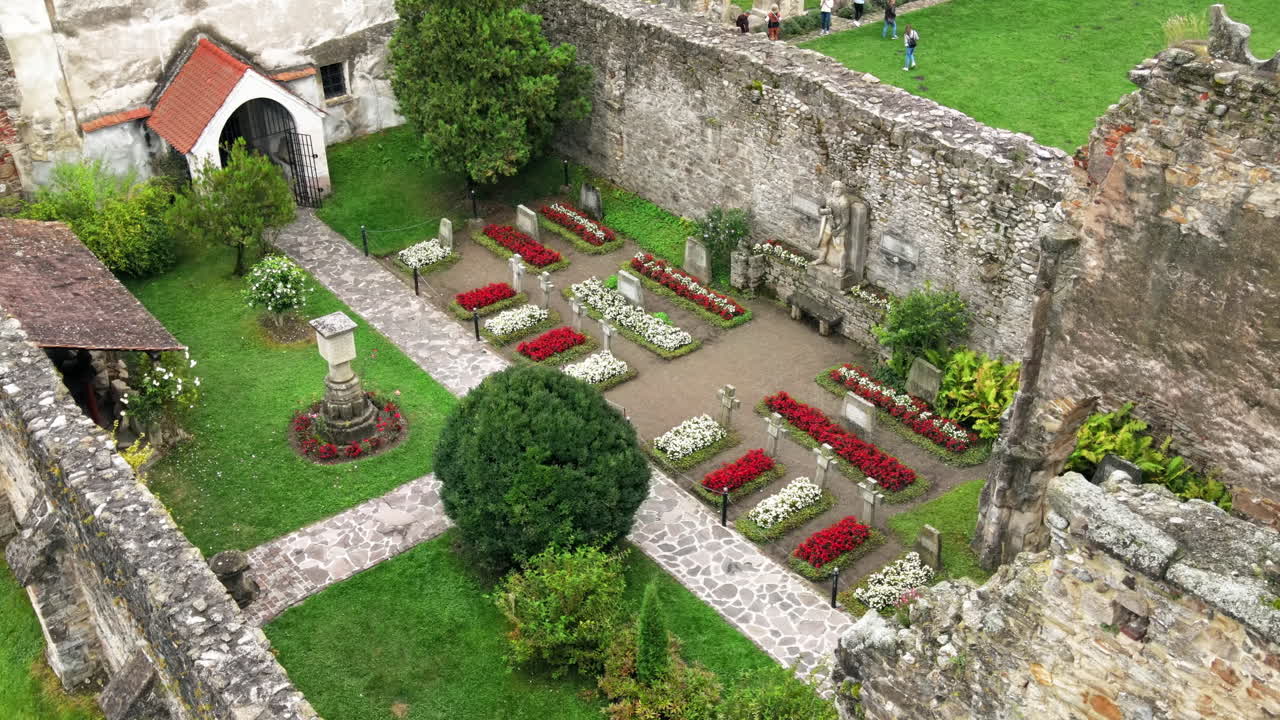 Aerial drone view of the ruins of medieval Cistercian abbey in Romania. Carta Monastery, medieval buidlings, greenery