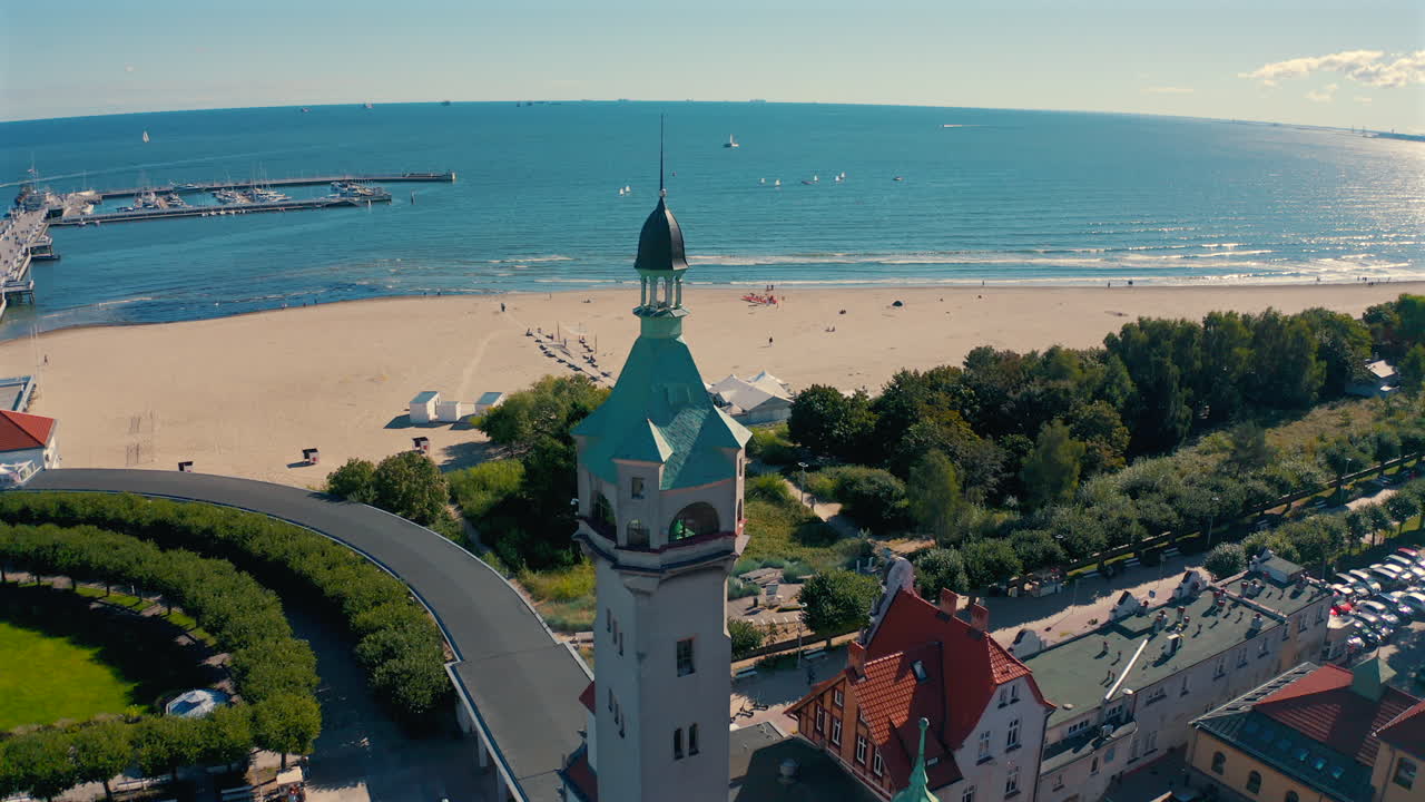 Drone flying from Sopot towards baltic sea with pier in the background at sunny summer day