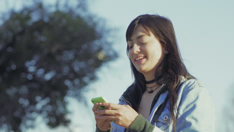 smiling teen girl reading good news from smartphone.