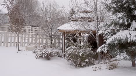 backyard gazebo in winter covered in snow