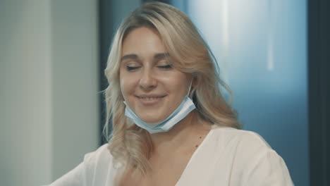 portrait of happy girl looking at camera with face mask indoor 1