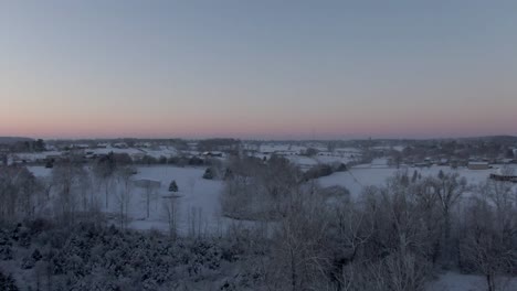 dolly forward over a snow covered countryside early in the morning