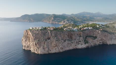 Aerial-panorama-of-Mirador-de-la-Mola-cliff-with-buildings,-Mallorca