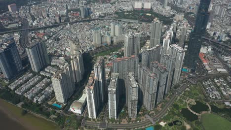 Aerial-view-of-Landmark-Central-Park,-Saigon-River-and-Ho-Chi-Minh-City-Skyline,-Vietnam-on-a-sunny-day