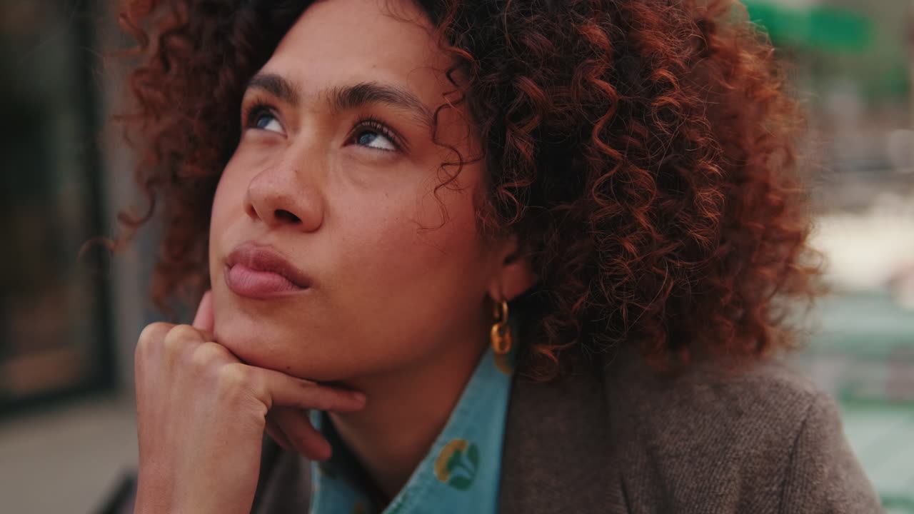 Thoughtful Young Woman Contemplates in City