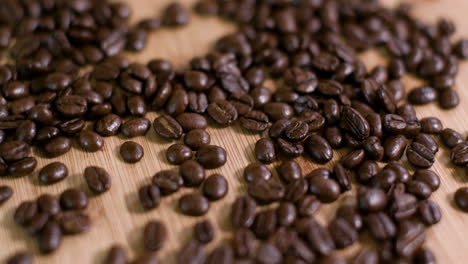 pile of coffee beans on wooden surface slow fly over 02