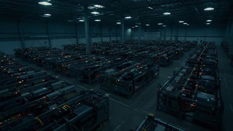 a vast array of industrial machines illuminated in a large warehouse, showcasing advanced technology and complex cabling in a dark environment