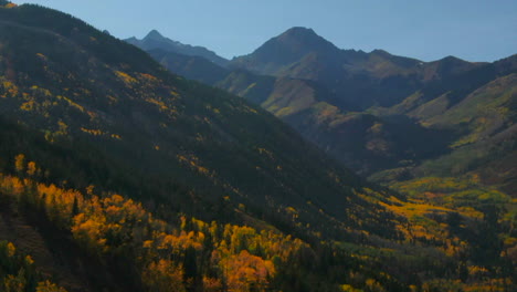 Colorado-summer-fall-autumn-colors-aerial-drone-cinematic-Aspen-Snowmass-Mountain-Maroon-Bells-Pyramid-Peak-beautiful-stunning-blue-sky-mid-day-sunny-backward-pan-up-reveal-movement