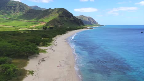 drone shot of a secluded white sandy beach in hawaii