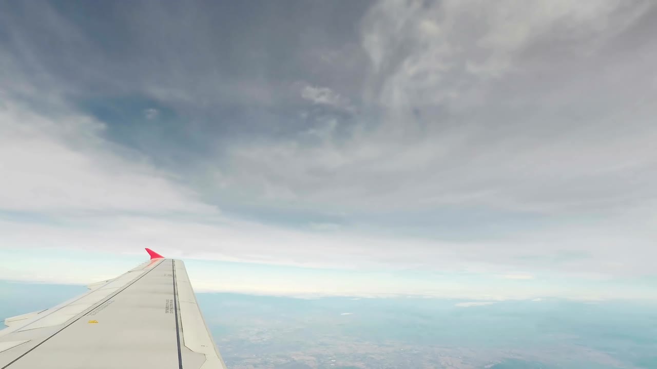 Timelapse video of airplane taking off and landing the airport along with sky and cloud as seen through window of an aircraft